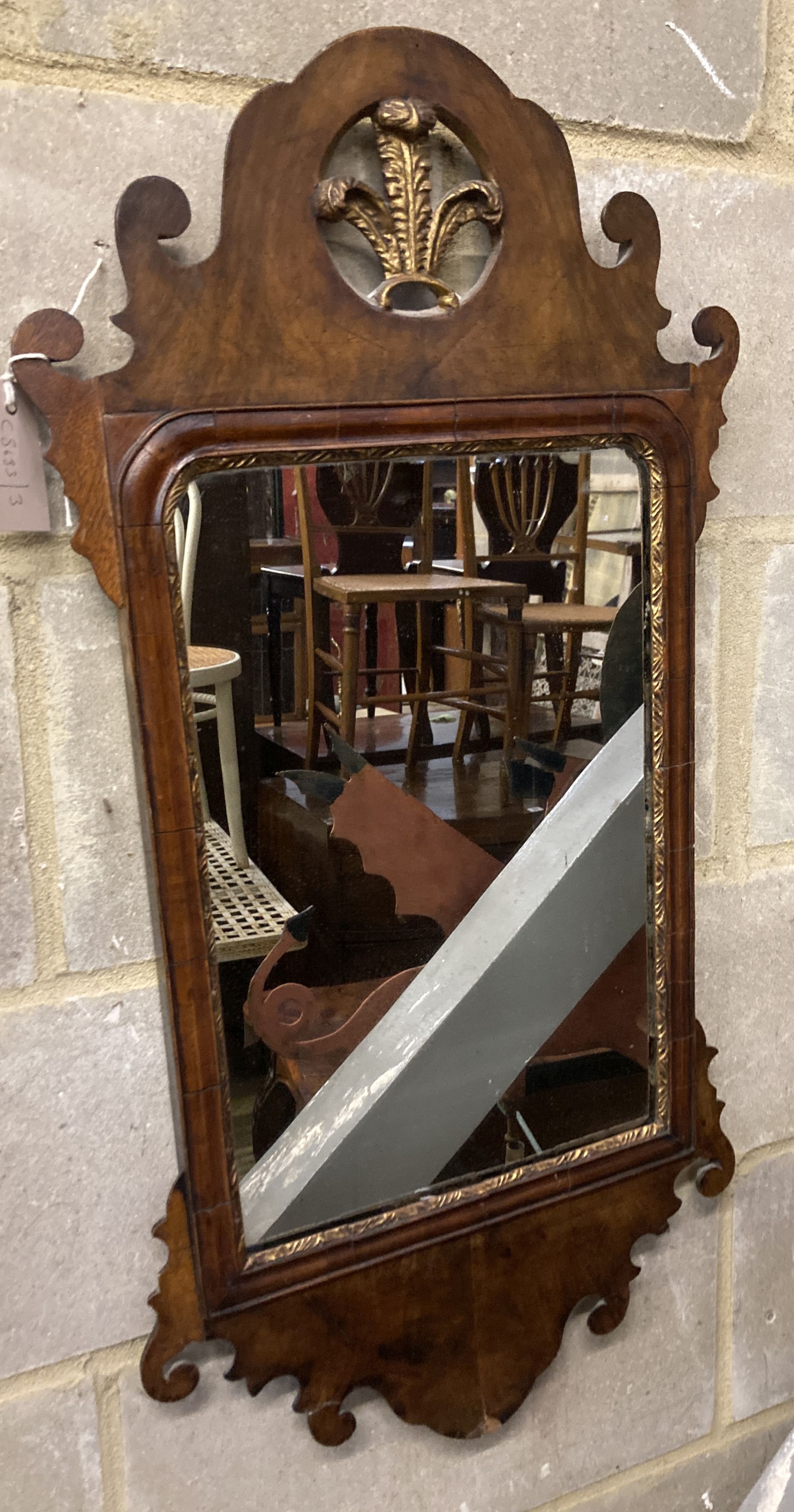 A George III style fret cut and carved giltwood domed top wall mirror, width 42cm, height 83cm